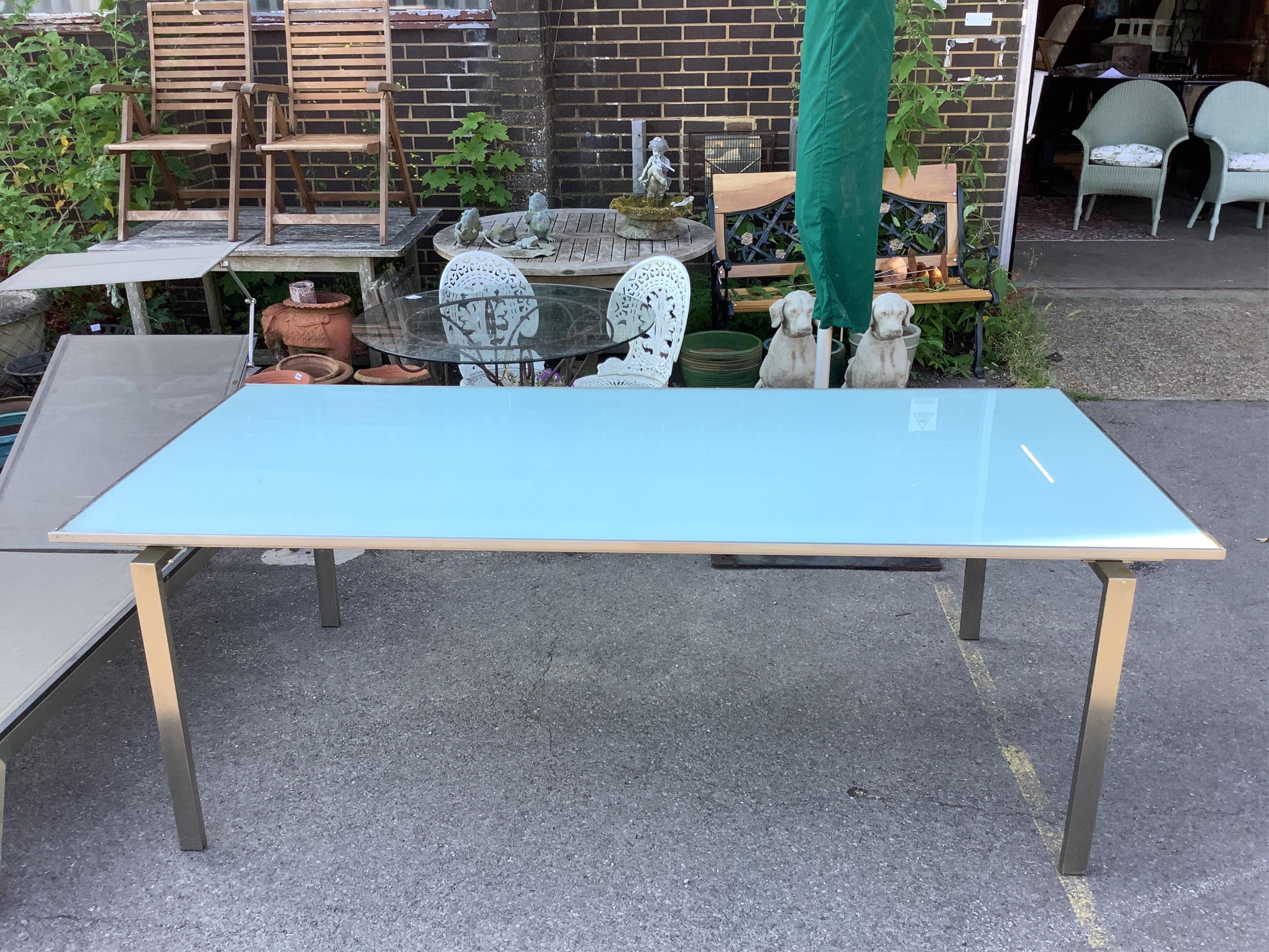 A Barlow Tyrie Mercury stainless steel (marine grade) glass top garden table, width 220cm, depth 101cm, height 74cm. Condition - fair